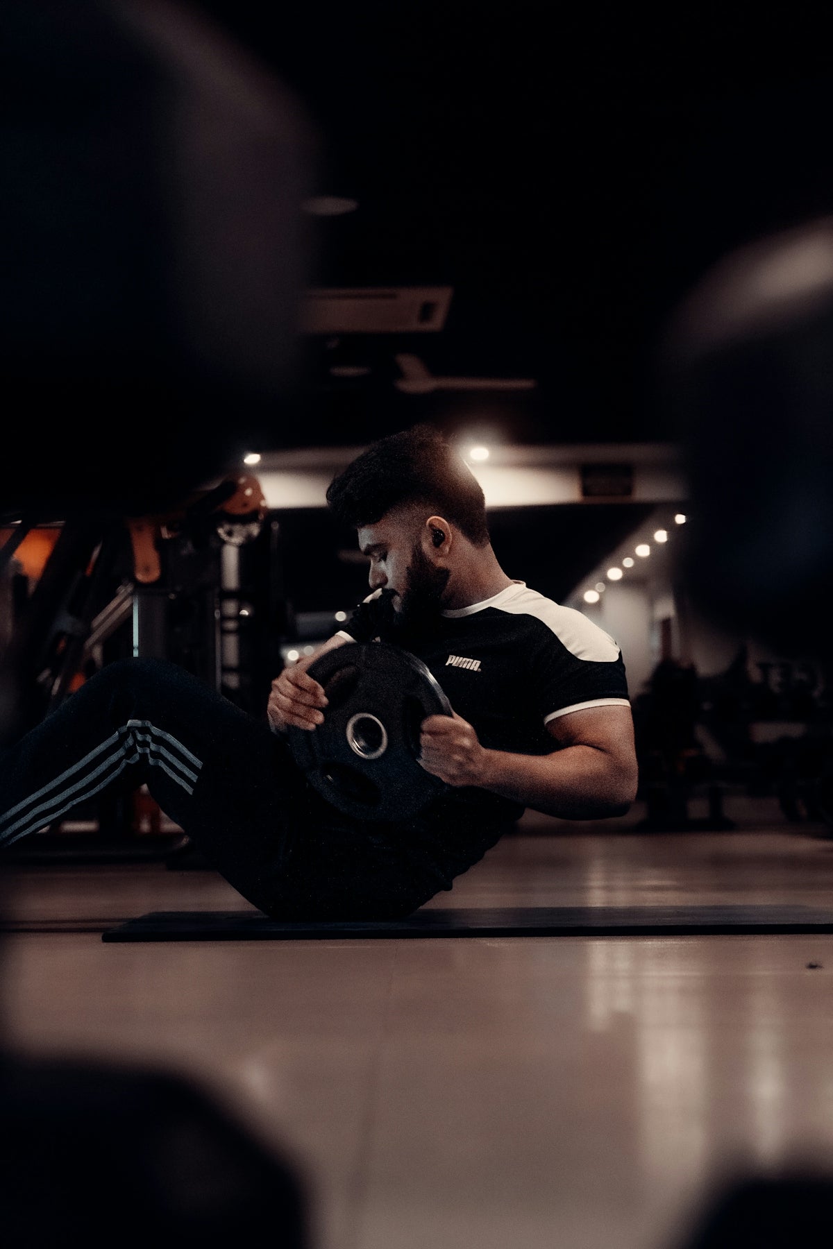 A man sitting on the ground in a gym