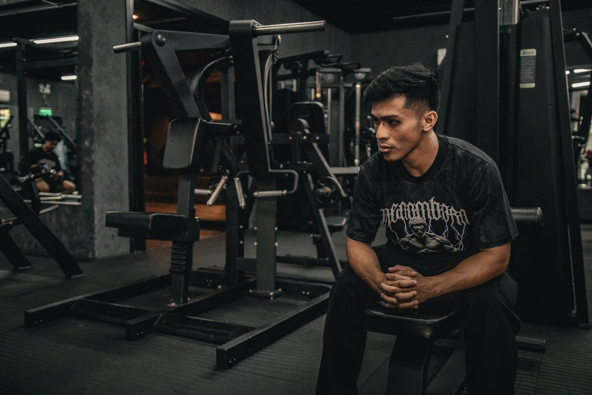 A man sitting on a bench in a gym