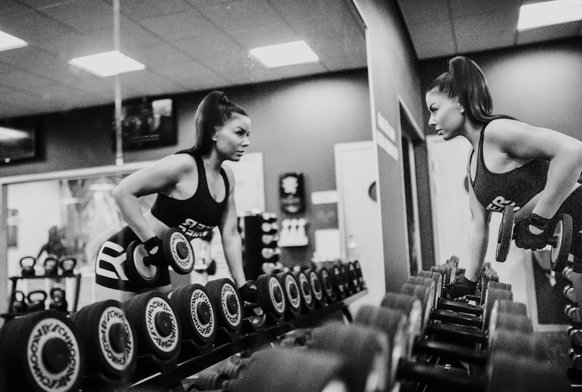 woman in black tank top and black shorts doing exercise