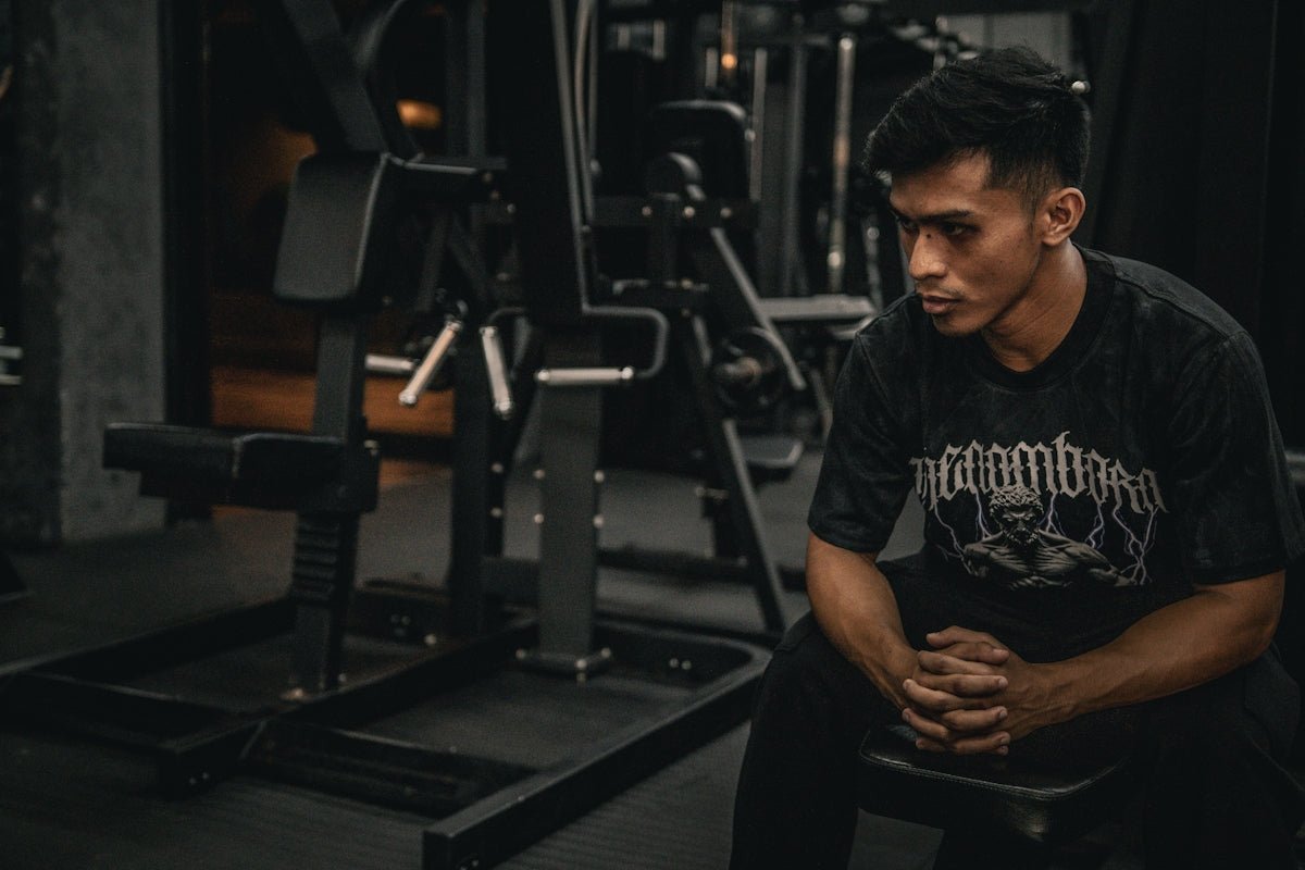 A man sitting on a bench in a gym